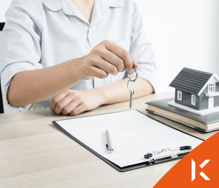 Real estate agent with house model and keys
